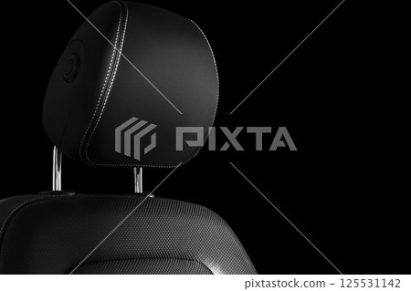 Modern luxury car leather interior. Part of leather car seat details with white stitching. Interior of prestige car. Comfortable perforated leather seats. Perforated leather. Car detailing. Black and Modern luxury car leather interior. Part of leather car seat details with white stitching. Interior of prestige car. Comfortable perforated leather seats. Perforated leather. Car detailing. Black and 125531142