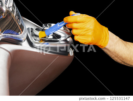 A man cleaning car with brush. Car detailing or valeting concept. Selective focus. Car detailing. Cleaning with sponge. Worker cleaning. Car wash concept solution to clean 125531147