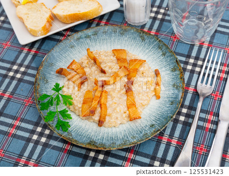 Oatmeal porridge served with fried lard Oatmeal porridge served with fried lard 125531423