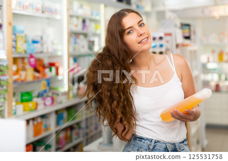 Young woman in drugstore Young woman in drugstore 125531758