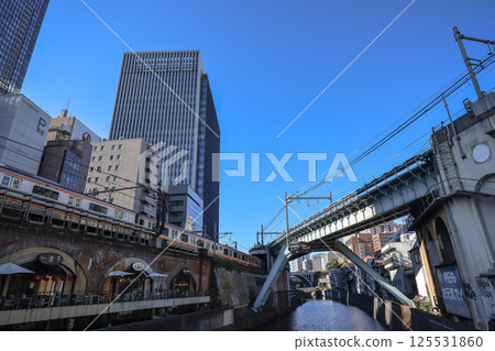 Waterfront Scene with Train, Bridge, and Modern Buildings, Tokyo Dec 10 2024 125531860