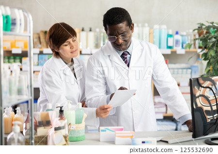 Woman and African man pharmacists at PC 125532690