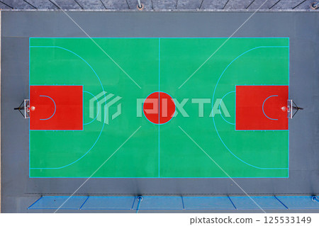 Aerial view of a freshly painted outdoor basketball court with vibrant colors 125533149