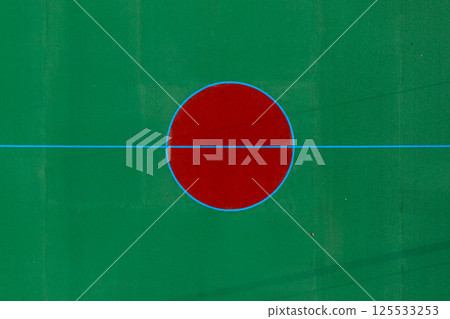 Red circle at the center of a green field with blue lines during daylight 125533253