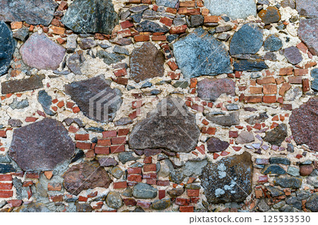 Colorful stone and brick wall texture showcasing natural materials in a rustic setting 125533530