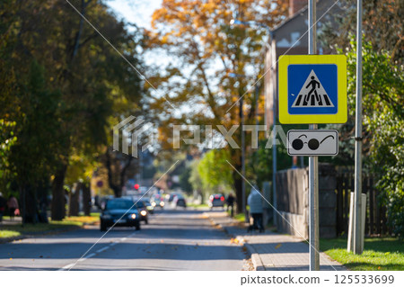 Pedestrian crossing sign on a sunny autumn day in a suburban neighborhood 125533699