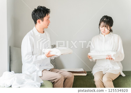 Couple fighting over folding laundry/housework Couple fighting over folding laundry/housework 125534920