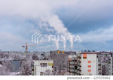 Aerial view of the city in winter with a smoking chimney 125535002