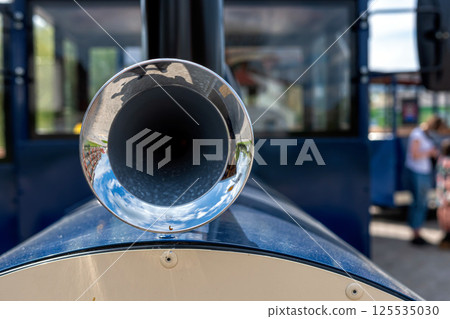 Close-up of the vintage horn on a blue car in the park 125535030