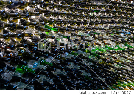 Wine bottles in a row on a stone wall. Close-up 125535047
