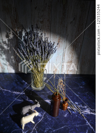 Felt toys of goats and donkeys, stems with lavender flowers in clay vases Felt toys of goats and donkeys, stems with lavender flowers in clay vases 125535244