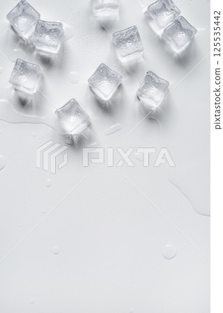 Melting ice cubes in a splash of water on a white background 125535442