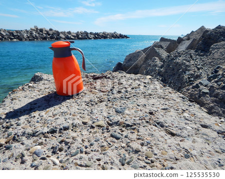 Orange thermos jug. Orange thermos jug. 125535530