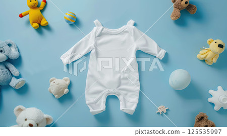 Baby white body suit on blue background with toys around. Cozy mockup, flat lay, top view 125535997