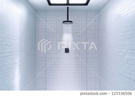 Compact shower area with sleek black frame glass doors and white subway tiles at a stylish angle 125536506