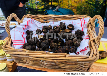 Expensive black truffles gourmet mushrooms in basket 125537139