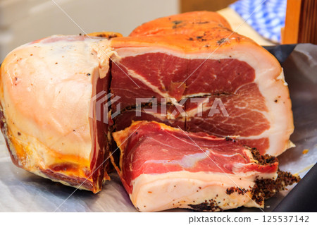Spanish ham, bellota, jamon serrano, crudo, italian prosciutto, parma ham on a table Spanish ham, bellota, jamon serrano, crudo, italian prosciutto, parma ham on a table 125537142
