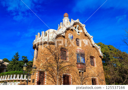 Fairytale gingerbread house in Park Guell designed by Antoni Gaudi in Barcelona, Spain Fairytale gingerbread house in Park Guell designed by Antoni Gaudi in Barcelona, Spain 125537166