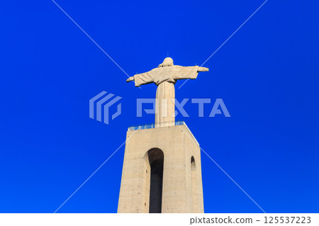 The Sanctuary of Christ the King (Cristo Rei) overlooking the city of Lisbon situated in Almada, in Portugal The Sanctuary of Christ the King (Cristo Rei) overlooking the city of Lisbon situated in Almada, in Portugal 125537223