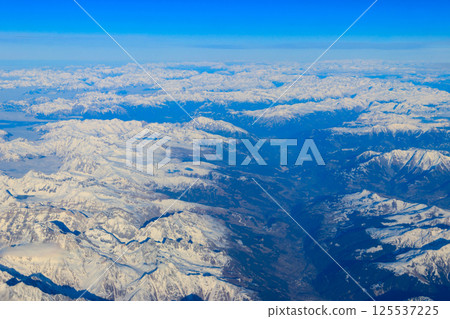 View of the Swiss Alps covered with snow from airplane View of the Swiss Alps covered with snow from airplane 125537225