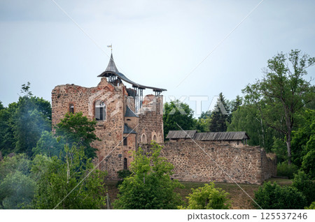 Ruined castle in latvia. Background with selective focus and copy space. Ruined castle in latvia. Background with selective focus and copy space. 125537246