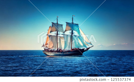 majestic ocean vessel sails through deep blue sea, its enormous sails catching wind under clear sky, creating serene and timeless scene 125537374