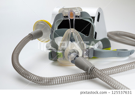 Continuous positive airway pressure system includes of CPAP machine, mask, tube on white background. Continuous positive airway pressure system includes of CPAP machine, mask, tube on white background. 125537631