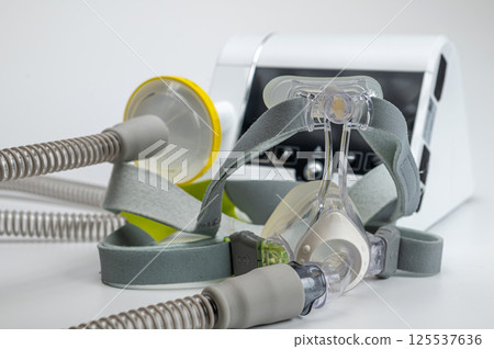Continuous positive airway pressure system includes of CPAP machine, mask, tube on white background. 125537636