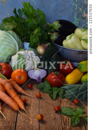 Assortment of colorful fresh vegetables including cabbage carrots and tomatoes on a rustic background ideal for vegetarian recipes organic market visuals and healthy lifestyle promotions Assortment of colorful fresh vegetables including cabbage carrots and tomatoes on a rustic background ideal for vegetarian recipes organic market visuals and healthy lifestyle promotions 125537650