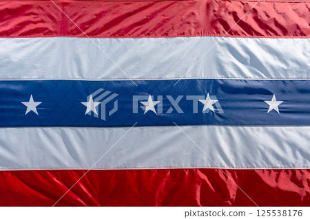 Close-up of a red, white, and blue patriotic flag with stars. USA 125538176