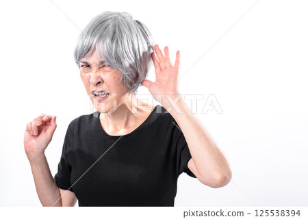 Senior woman complaining that she can't hear Senior woman complaining that she can't hear 125538394