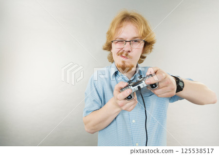 Gamer man holding gaming pad Gamer man holding gaming pad 125538517