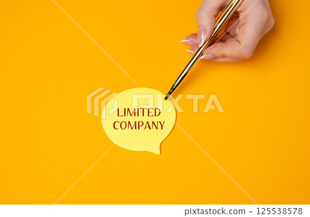 Limited company concept. Type of business structure where the company's liability is limited to the amount of money invested in the business by its shareholders. A woman points to a note with a pen 125538578