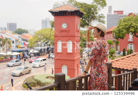 woman in dress and hat exploring vibrant streets of Malacca, Malaysia. woman in dress and hat exploring vibrant streets of Malacca, Malaysia. 125539496