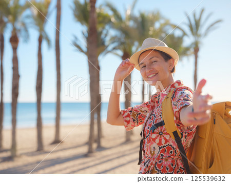 Woman strolls through colorful streets of Spanish coastal town 125539632