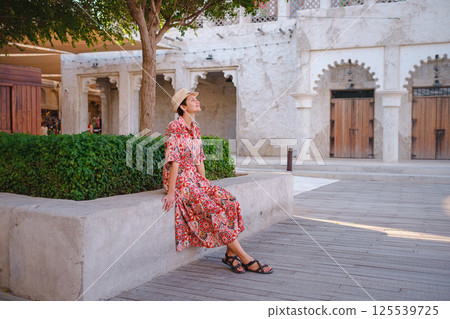 Young female tourist exploring iconic landmarks of the United Arab Emirates. Young female tourist exploring iconic landmarks of the United Arab Emirates. 125539725