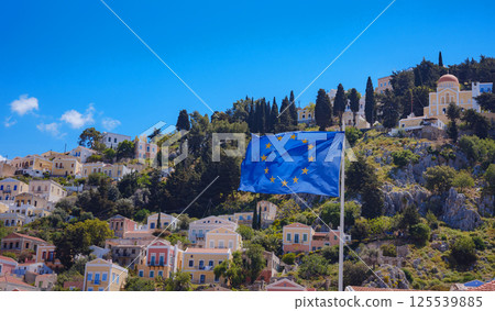 View of Greek flag waving in air serene Mediterranean vibe. View of Greek flag waving in air serene Mediterranean vibe. 125539885