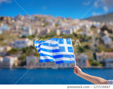 View of Greek flag waving in air serene Mediterranean vibe. View of Greek flag waving in air serene Mediterranean vibe. 125539887