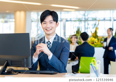 Young businessmen working in an office. Photo courtesy of Denpa Gakuen, Tokyo Electronics College. 125539946