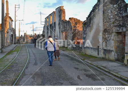The people near destroyed building during World War 2 in Oradour- sur -Glane France 125539994