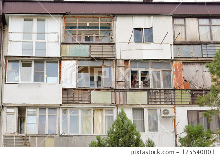 Ruined old poor house with balconies 125540001