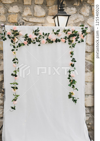 Arch decoration of flowers on white background for photographing newlyweds and guests Arch decoration of flowers on white background for photographing newlyweds and guests 125540020
