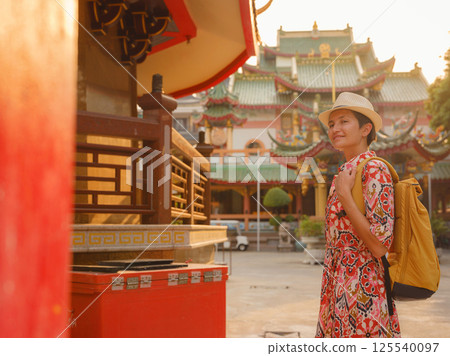 Woman Exploring Colorful Streets Near Buddhist Temples in Bangkok 125540097