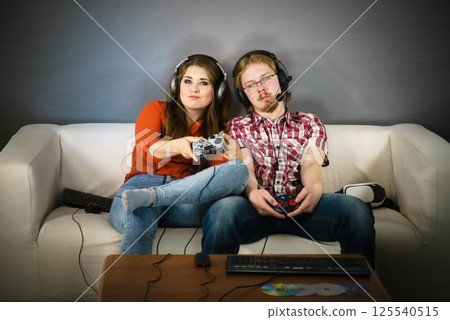 Gaming couple playing games 125540515