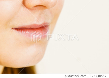 Girl with no makeup, part of face lips 125540537