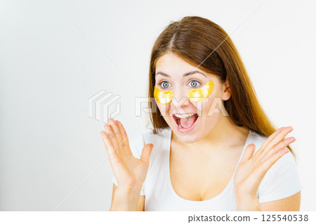 Woman with gold patches under eyes 125540538
