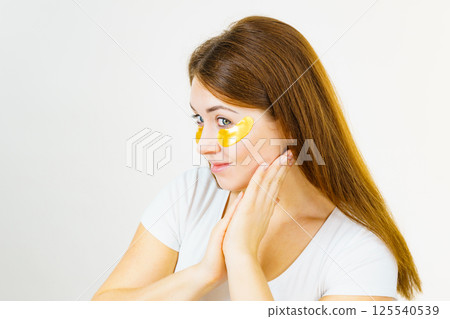 Woman with gold patches under eyes 125540539