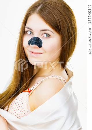 Woman with nose mask pore strips Woman with nose mask pore strips 125540542