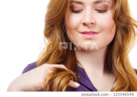 Woman with long hair shows healthy ends Woman with long hair shows healthy ends 125540549