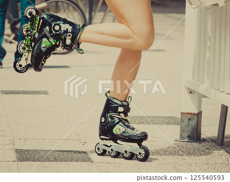 Woman legs wearing roller skates 125540593